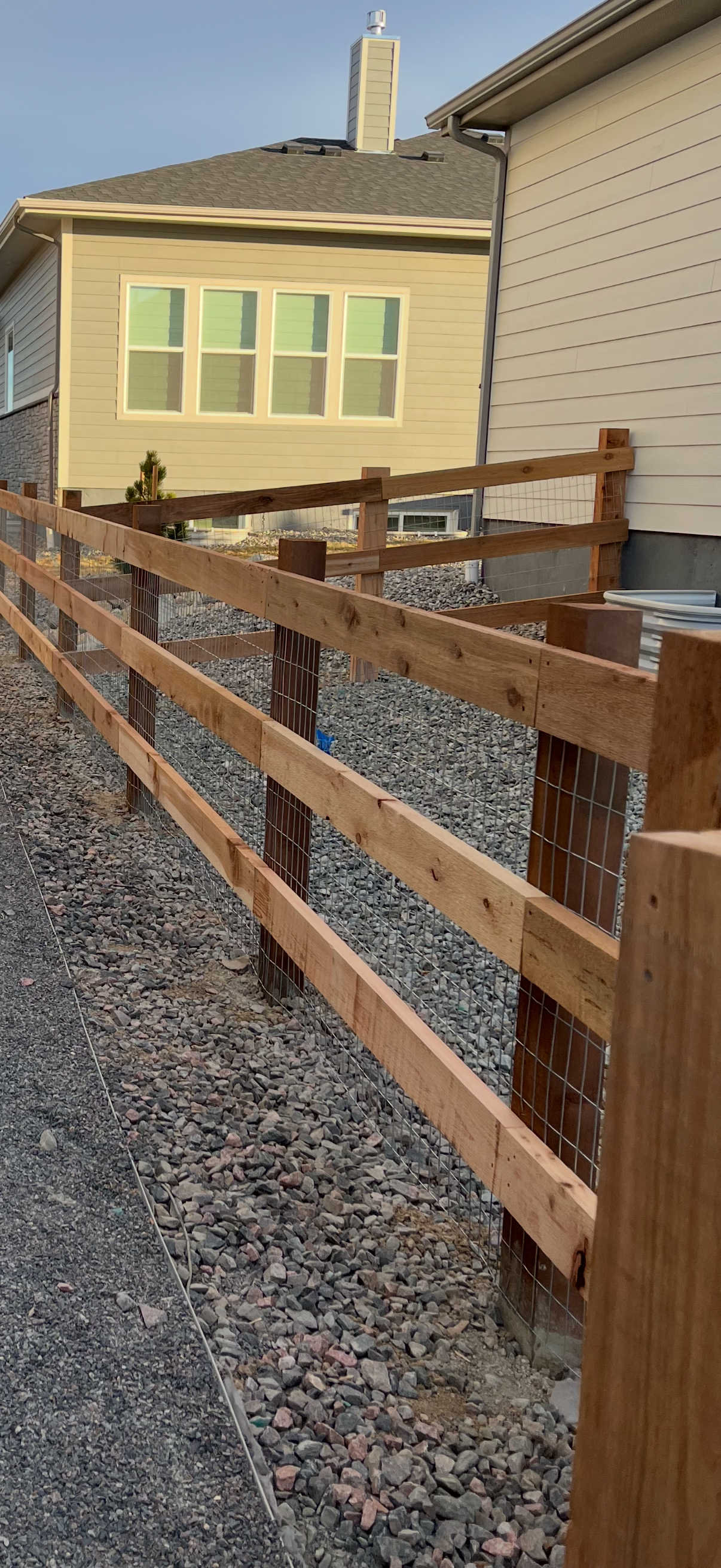 Wood fence along ranch-style property — fence contractor serving Loveland and Windsor, CO