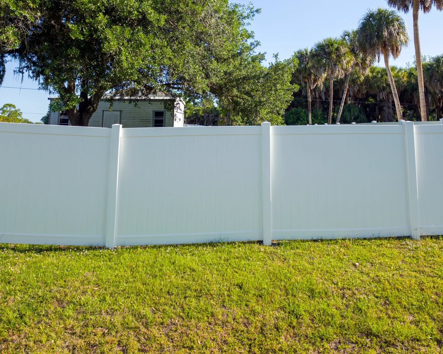 White vinyl privacy fence installed on a residential property in Northern Colorado